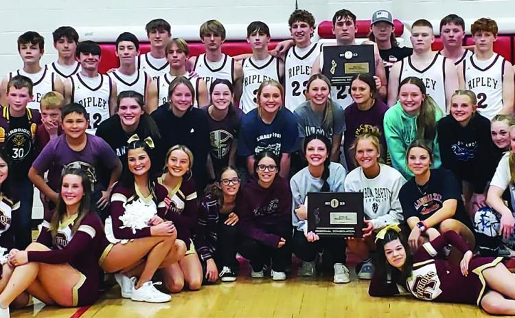 Ripley Warriors and Lady Warriors both stand with their Regional Consolation Championship placards after the Ripley warriors game against the Garber Wolverines Saturday, Feb. 18. The Warriors beat Garber 43-42 with a half court buzzer beater shot. Lady Warriors beat Hominy 41-29. Both teams will play Oklahoma Bible Academy in the first round of the OSSAA Class A Area Tournament at the Stride Bank Event Center in Enid Thursday, Feb. 23. Girls play at 6 p.m. with boys game to follow.