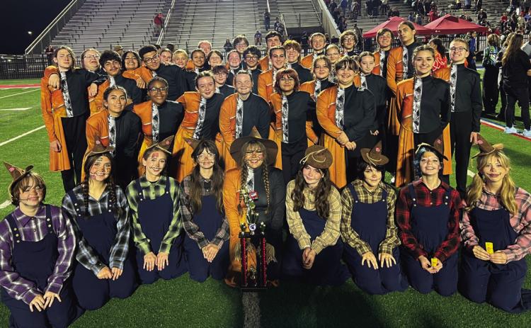 The Cushing Tiger Marching Band stands with their 3rd place trophy after the preliminary round at the Bixby Tournament of Bands.