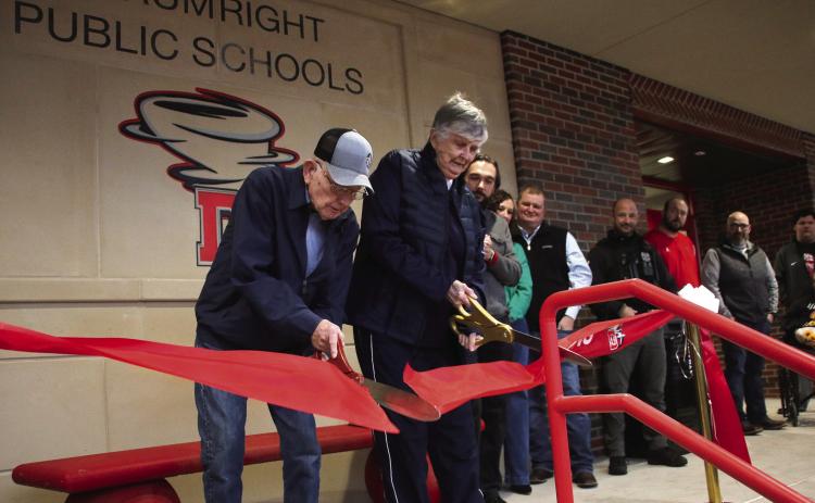 Coach Otis Stump and Dr. Virginia Peters cut the ribbon to open the new Activity Center at Drumright High School, Jan. 29. Photo by Allie Prater