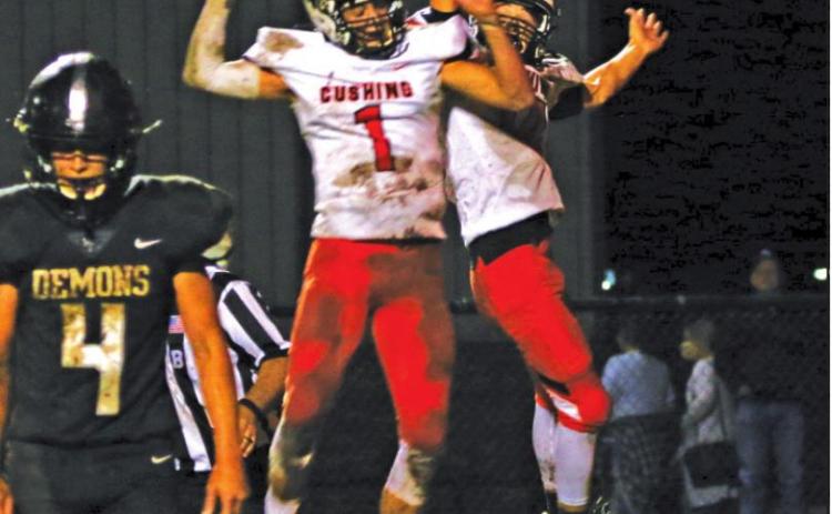 Blaze Berlowitz and Austin Munday celebrate a TD pass during the Tigers 27-7 victory over country rival Perkins-Tryon Friday. Berlowitz threw for 340 yards.