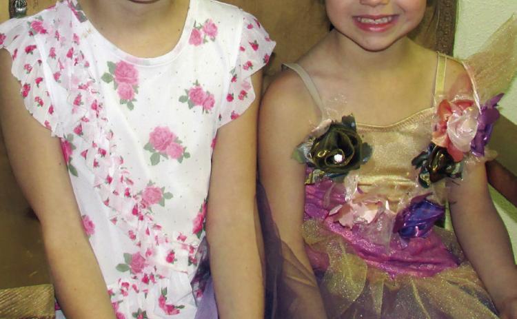 Addie Fox and Mia Fox sit upon a golden throne dressed in their best garb while participating in the Cushing Public Library’s annual Tolkien Week event, the Hobbit Party. Participants earned tickets to the party by following riddles and clues in relation to the J.R.R. Tolkien written series that follows the adventures of Bilbo Baggins. More on page 10. Photo by DeAnna Maddox