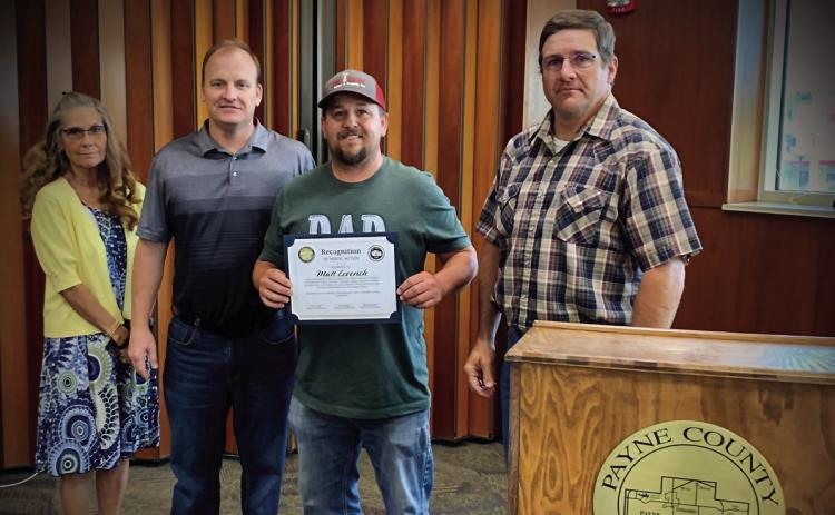 Matt Leverich receives a certificate of recognition from the Payne County Board of Commissioners for his heroic actions. Pictured from left, Commissioner Rhonda Markum, Commissioner Seth Conley, Matt Leverich, Commissioner Zach Cavett.