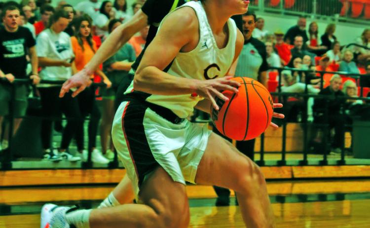 John Hilligos pulls up at the baseline in the Tigers’ 58-49 win over Woodward last week. Photos by Amber Fausto