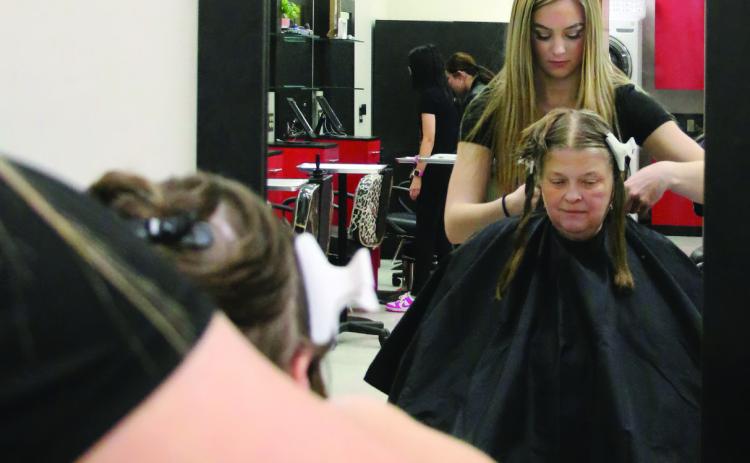 First year cosmetology student at Central Tech and Yale High School junior RyLee Reece cuts Kenna Conners’, of Bristow, hair during the Central Technology Center Open House on Sunday, Feb. 18. Photo by Allie Prater