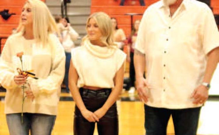 Jade Morgan escorted by her Shane and Laura Morgan.