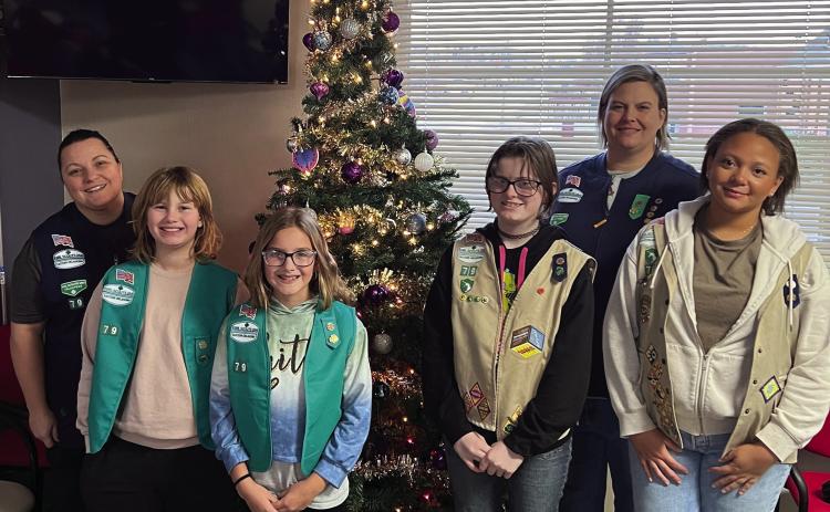 Girl Scout Troop 790 went to the Cushing Marketplace last Sunday on Nov. 30 to decorate for Christmas. Pictured in back is Troop Leader Laura Green and Co-Leader Karen Schmitt-Page. Troop members pictured from left are Vivian Richard, Addison Fox, Alice Green, and Alexa Page. Other members who helped with the recent donation drive but was unable to decorate are Sadie Maxwell, Arhyanna Tusler, Rhylynn Garcia, Teresalynn Parson, and Brooklyn Pierce.