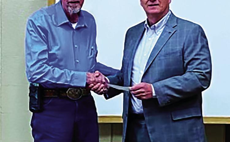 Leroy Kalka, Chairman of Cushing Regional Hospital Foundation presents a check to Mid Griffith, Chairman of Cushing Board of Commissioners, for $44,051.21 to purchase a set of orthopedic operation equipment. Dr. Hanson, orthopedic surgeon, requires two sets. In the event something goes wrong during surgery, he has a backup. Dr. Hanson is now handling several cases a week at Cushing Hospital. The City of Cushing agreed to help purchase the set.
