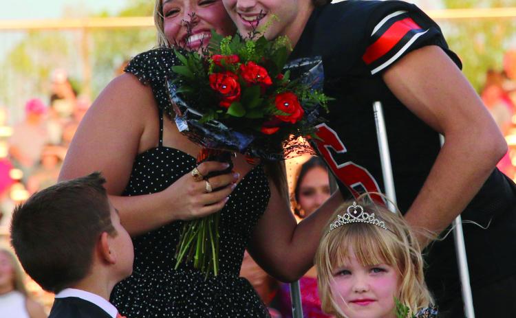 Max Wood and Maddie Collier celebrate after being crowned 2024 Cushing Tiger Homecoming King and Queen during homecoming festivities Friday night while crown bearer Kannon Fowler and flower girl Landry Morgan look on. Photo by Allie Prater. More photos page 12.