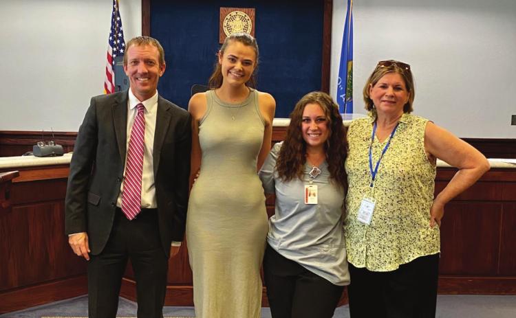 Payne County Judge Michael Kulling swears in CASA volunteers Paige Marttindale, Kylie Hager &amp; Marie Russell.