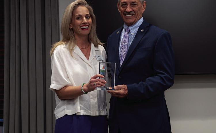 Autism Foundation of Oklahoma Executive Director Emily Scott presents Rep. John Talley with the 2023 Advocate of the Year Award.