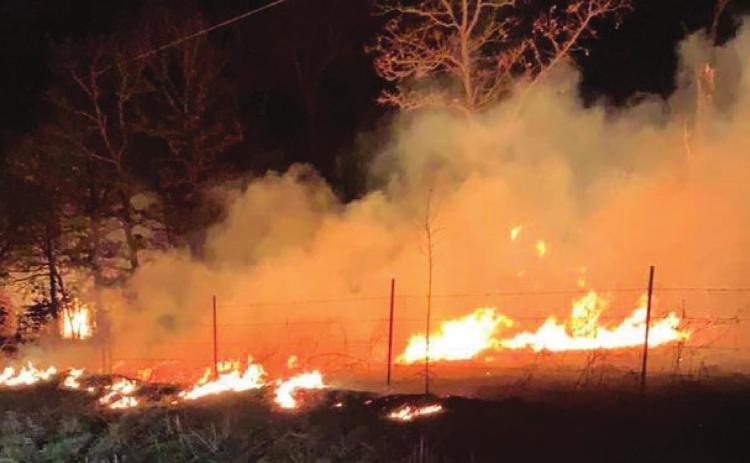 Grass fire threatens structures and cattle