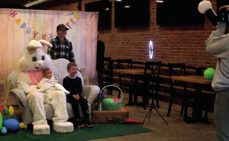 The Hamm siblings, Wyatt, Gage, and baby Ava, ham it up for their photo with the easter bunny during the Gibble Easter Festival Saturday, April 19. Photo by Allie Prater