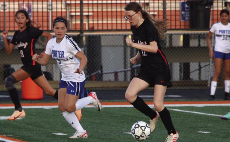 Cushing Lady Tiger Bella Keyes dribbles down the field during the Lady Tigers game against Porter, Tuesday, March 5. Lady Tigers lost 0-7. Lady Tigers will play again Friday at home against Newkirk. Photo by Allie Prater