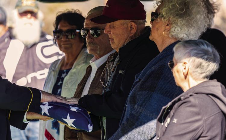 A folded American flag is presented to Robert Walker, nephew of Corporal James McKinley Walker, during graveside services Friday at the IOOF Cemetery in Maramec, honoring the Pawnee native who died as a prisoner of war during World War II and was returned home more than 80 years later. Photo by John Burns