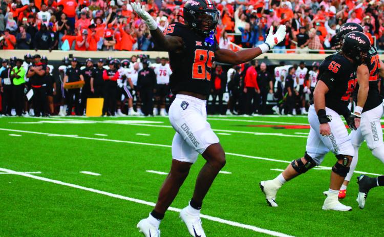 OSU’s Jaden Bray throws shrugs in celebration after a Cowboys touchdown.