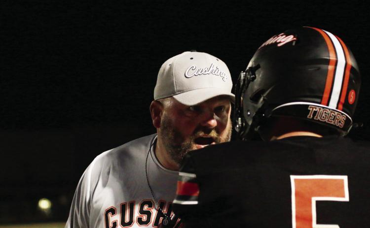Tiger head coach Rusty Morgan leans in with a dose of hard-earned wisdom for senior Cole Cooper during Friday’s 4A football playoff clash with Hilldale. Cushing defeated Hilldale 63-34 and advanced to the second round where they will host Ardmore, this Friday, at O’Dell Field. Story, Page 8 Photo by J. D. Meisner