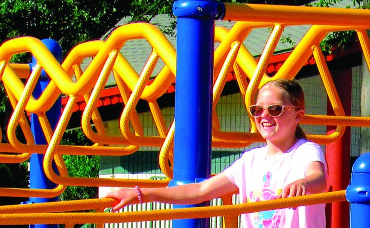 Sunshine and smiles take center stage in Memorial Park this week, as Dusti Hoover explored the playground. More sun and fun images inside. Photo by Deanna Maddox