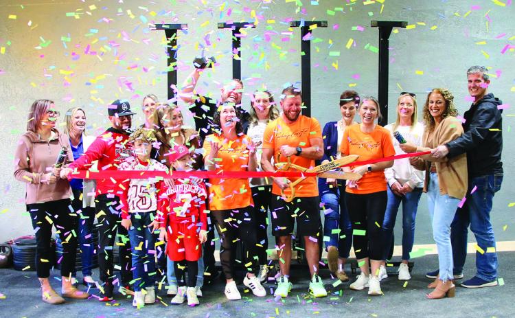 Tyler Ashbaugh, owner of Cushing CrossFit cuts the red ribbon for the grand opening of his new CrossFit gym in downtown Cushing, Friday Nov. 10. Cushing CrossFit is located at 114 W Broadway with classes available from 5 a.m. to 6 p.m. Photo by Allie Prater