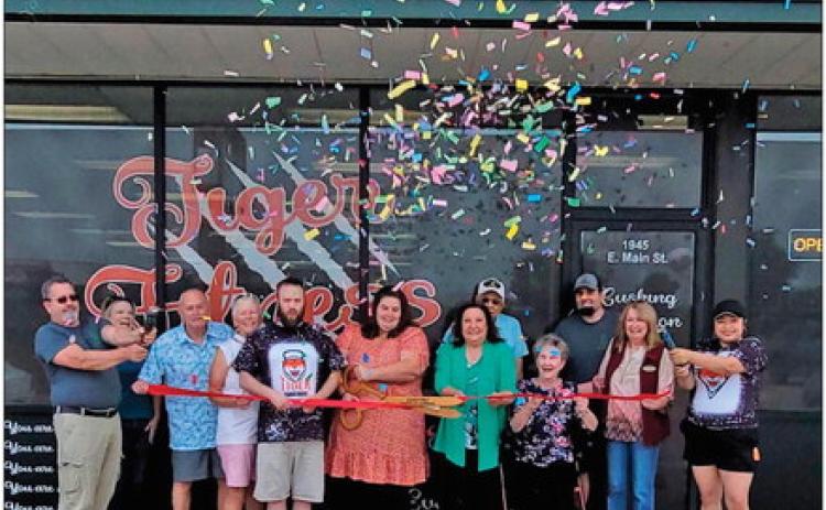 New owners of Tiger Nutrition and Tiger Fitness cut the ribbon during the reopening ceremony hosted by Cushing Chamber of Commerce members.