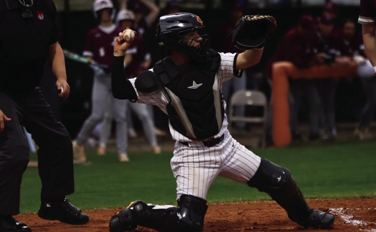 Braxton Colclasure loads up a pick-off throw during the Tiger’s opener against Ada. Photo by Sylvia Danyelle