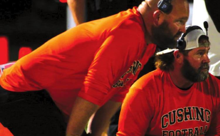 Coaches Rusty Morgan and J Moore discuss strategy Friday.