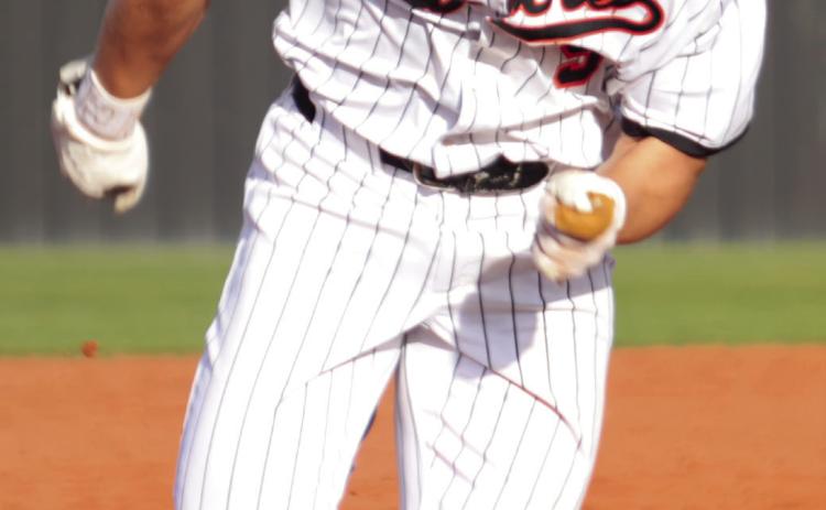 Brody Robinson turns and burns toward third base Monday against the Glenpool Warriors.