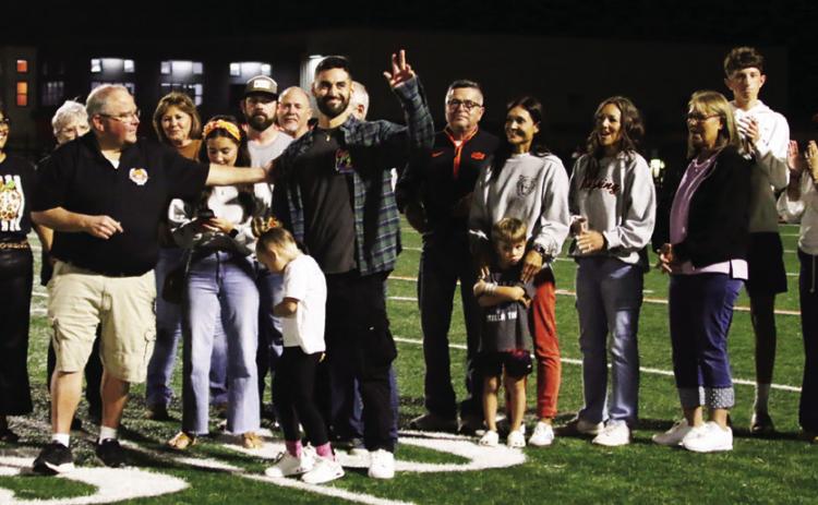 Cushing Alum Travis Peery congratulates Justin Bogle while his family and friends join in celebrating his induction into the Cushing Hall of Fame. Bogle made his way to the very pinnacle of Supercross racing in America and abroad. Pboto by J. D. Meisner