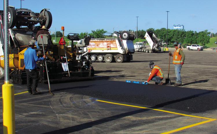 Crews were out at Cushing Wal-Mart on June 26 repaving a section of the parking lot to improve the surface to give locals a smooth ride to pick up their pre-holiday supplies. The project included a layer of fresh asphalt and new striping to enhance safety and traffic flow. Photo by DeAnna Maddox.