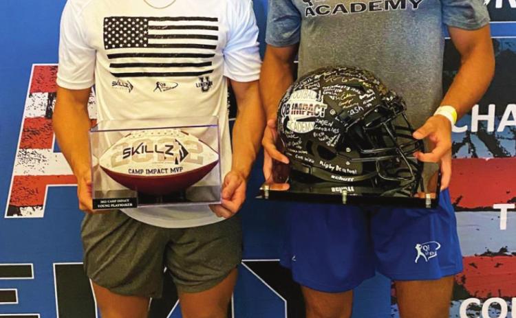 Camden Crooks and Blaze Berlowitz hold their MVP trophies at the QB Impact Academy football camp held at AT&amp;T Stadium in Arlignton, Texas.
