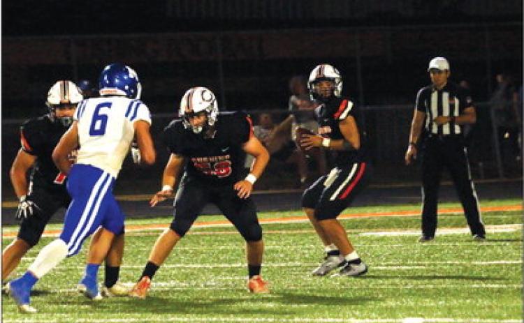 Quarterback John Hilligos looks for an open receiver. He threw for 290 yards last week and three TDs.