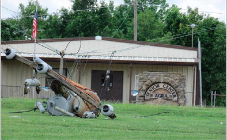 A fallen power line pole lays in front on the senior center in Agra. Photo by DeAnna Maddox.