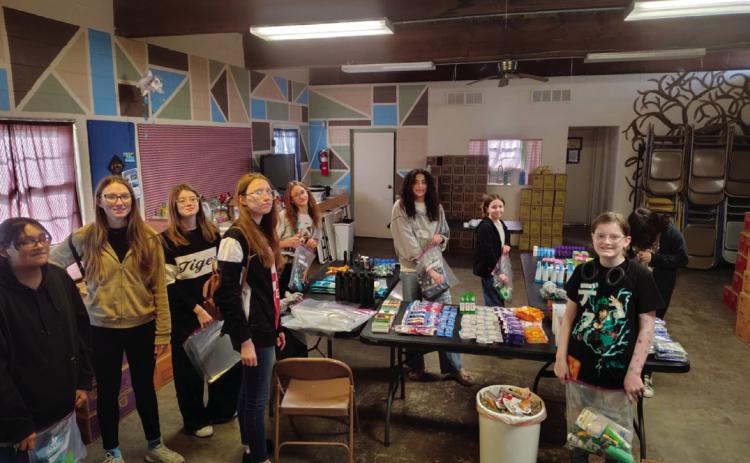 Troop #79 members who were present to package hygiene bags were Tegan Fincher, Kira Keyes, Willow Keyes, Bella Keyes, Rhylynn Garcia, Aubrey Roberson, Everley Ewy, Alice Green, and Brooklyn Pierce. Additionally, Arhyanna User, Alexa Page, Addilyn Fox, Addison Kidder, Sadie Maxwell, Teagan Williams, Vaeda Nugent, and Vivian Richard also contributed items to be donated but were unable to attend the packing party.