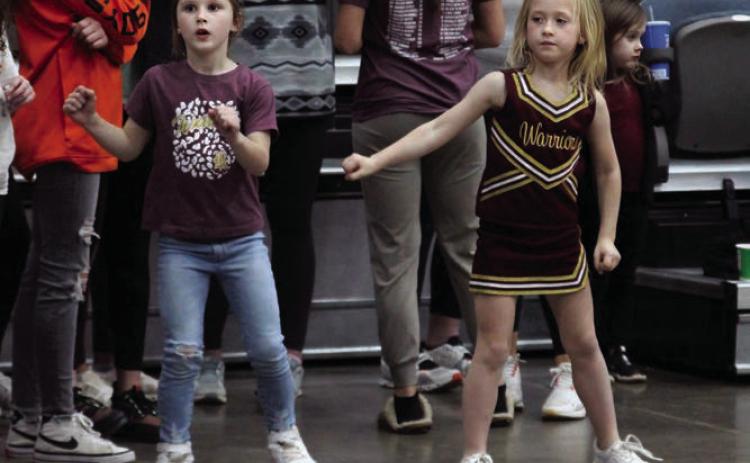 Ellis Billingslea (left), and Lainey Pitts (right), cheer on the Warriors in their 40-34 victory over OBA in the Area semi-final.