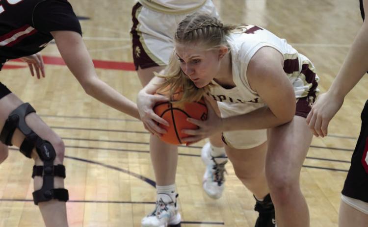 Brooklyn Howell powers through OBA defenders on her way to the basket. Photo by Kaleb Tadpole
