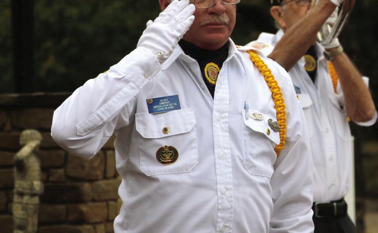 Legionnaire GW Davis salutes as Robert “Chef” Howell plays taps during the flag retirement ceremony at the Donaldson/ Walker Cushing-Drumright American Legion Post 108 Oct. 25. Photo by Allie Prater
