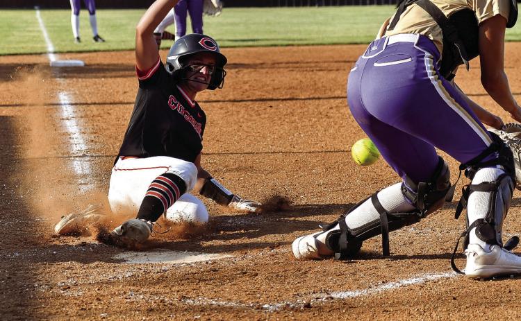 Freshman Macie Townes slides into home. Townes went three for three in the batters box against Davenport, scored one run and had three RBIs. Photos by Sarah Townes