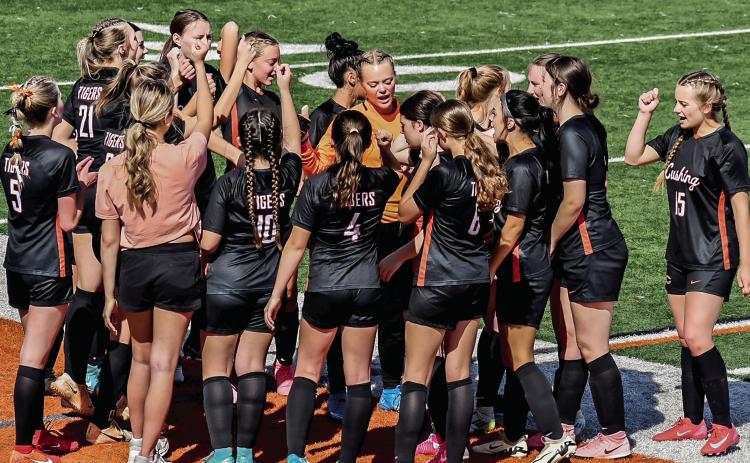 The Cushing Lady Tigers Soccer team huddle before their match against Casady on Tuesday, April 2. Photo by Sarah Townes.
