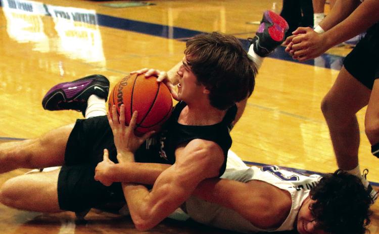 Max Wood goes to the hardwood in a battle for possession. Photos by J. D. Meisner