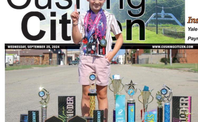 Connor Cline shows off his hardware in downtown Cushing. Photo by Allie Prater.
