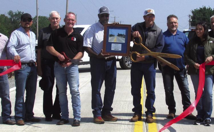 Commissioner Cavett performs the ribbon cutting in celebration of the long awaited completion of the Norfolk Road project which took a decade plus, two engineer companies, and $4.8 million.