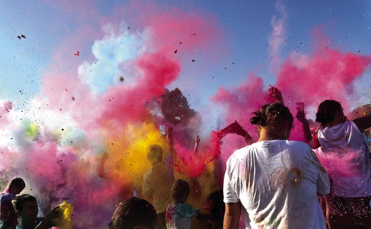 Participants in the 2025 Do or Dye color run hosted by the Cushing Geographic Club throw powder for the color explosion following the 5k Saturday, Aug. 16 at Memorial Park. See more photos on page 10. Photo by Allie Prater.