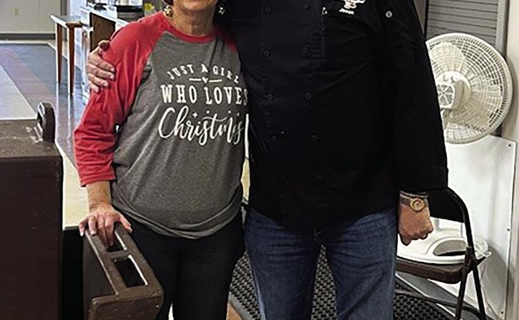 Debbie Brown, director of the Senior Citizen Center, stands with Jason Kinsey of Steer Inn Cushing after Kinsey donated and delivered a Christmas feast for local seniors. The meal included barbecue pulled pork, mashed potatoes and gravy, green beans, rolls and apple cobbler, serving 81 seniors at the center and providing 30 meals to homebound residents.