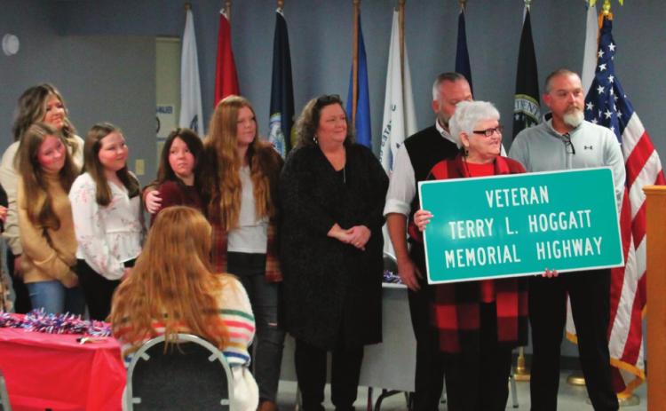 Representative Talley presents a ceremonial road sign dedication to the multitude of family members of Terry Hoggatt during the dedication held at the American Legion Post 108 on Nov. 11.