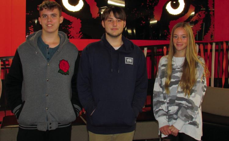 Cushing High School students — Austin Randall, Keegan Houtchins, and Emory Eyler all had art selected to be part of a performance celebration in honor of John Williams following a statewide contest in which only 12 artworks were chosen.