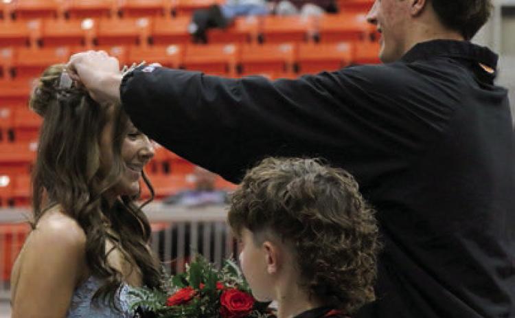 King Bryce Ward crowns Queen Laramie McCoy as crown bearer Easton Wright watches on. Photo by Allie Prater