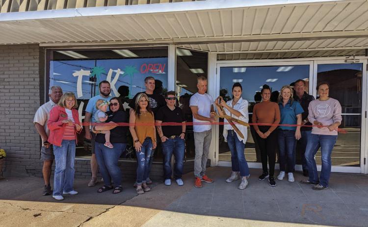 Chamber of Commerce members attended the ribbon cutting ceremony for Tiki Hut located at 221 North Cleveland Avenue, on Friday, Oct. 14. Pictured from left are John Rhoten, Tanya Rhoten, Geoff Beasley, Shawnee Ralston holding Lilah Beasley, Dana Cramer, Brandon Wolff, Tera Shooley, Tiki Hut Co-Owner Brian Demark hold the scissors with Owner Naveah Taylor-Tennison standing to the left of Co-Owner Carol Medford, Chamber President/CEO Tracy Caulfield, John Moran, and Sarah Townes. Photo by Afton Pierce.
