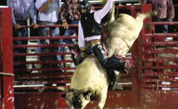 Donald Holmes, from Geronimo, holds on tight trying hard to meet that eight second qualifying time for bull riding on July 16.