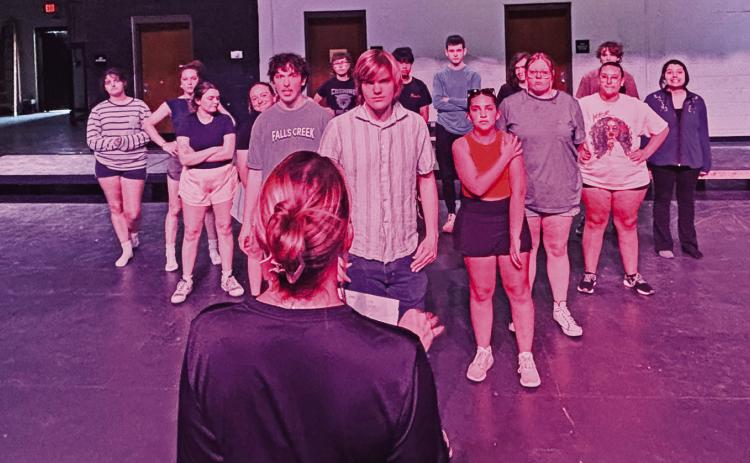 Emily Moore offers direction to cast members of the upcoming performance of “Footloose” the musical during a recent rehearsal to prepare for the spring production.