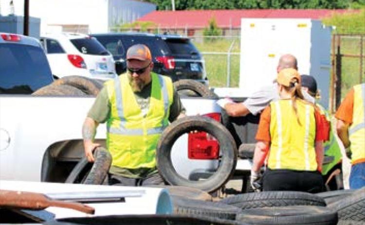 Cushing City Emplopyee Jeremy Brown unloaded tires at the city yard.