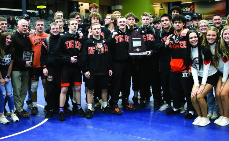 The Cushing Tiger wrestling family stands with a runners-up plaque commemorating their second place win at the OSSAA Dual State Tournament in Enid Friday, Feb. 9. See inside for more details. Photo by Allie Prater.